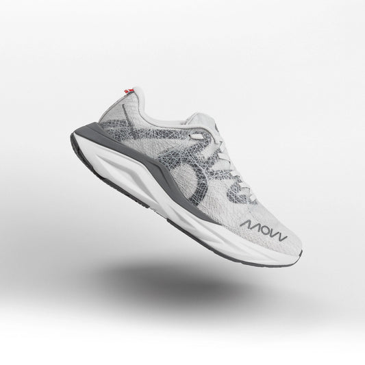 A white and grey athletic running shoe with grey midsole photographed against a light gray background. The shoe features a white mesh upper material, white laces, and MOVV branding visible on the side.
