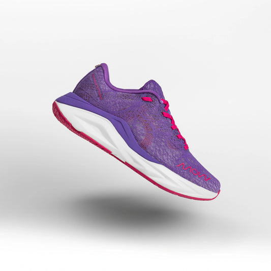 A purple and pink athletic running shoe with purple midsole photographed against a light gray background. The shoe features a purple mesh upper material, pink laces, and MOVV branding visible on the side.