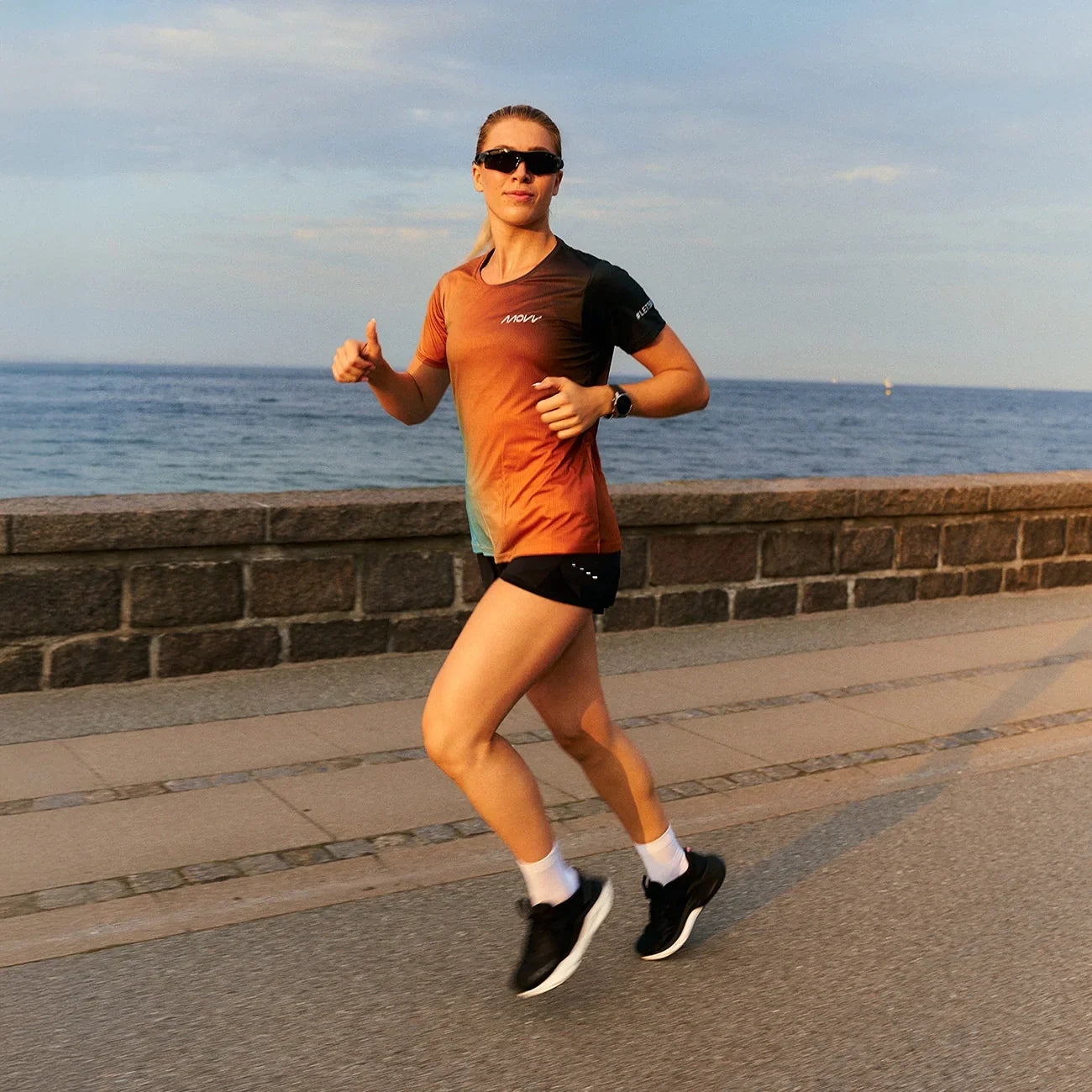 Person running along a coastal path with ocean view