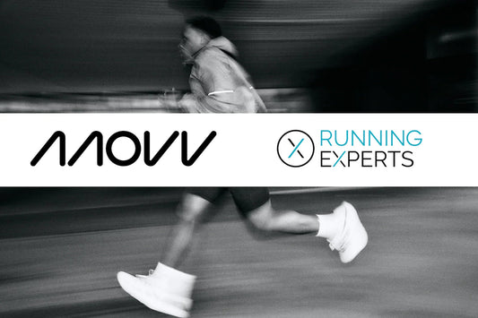 Black and white photo of a runner in motion wearing white and grey minimalistic running shoes for injury reduction